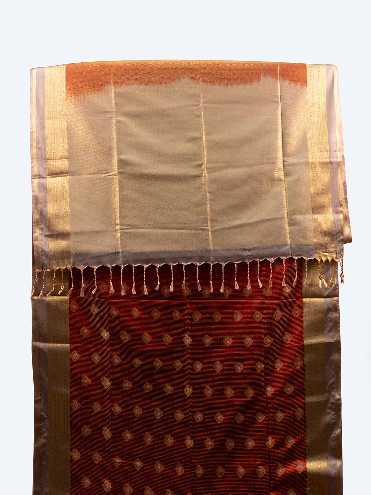 Maroon soft silk saree with gold zari buttas, contrast zari border and cream zari pallu