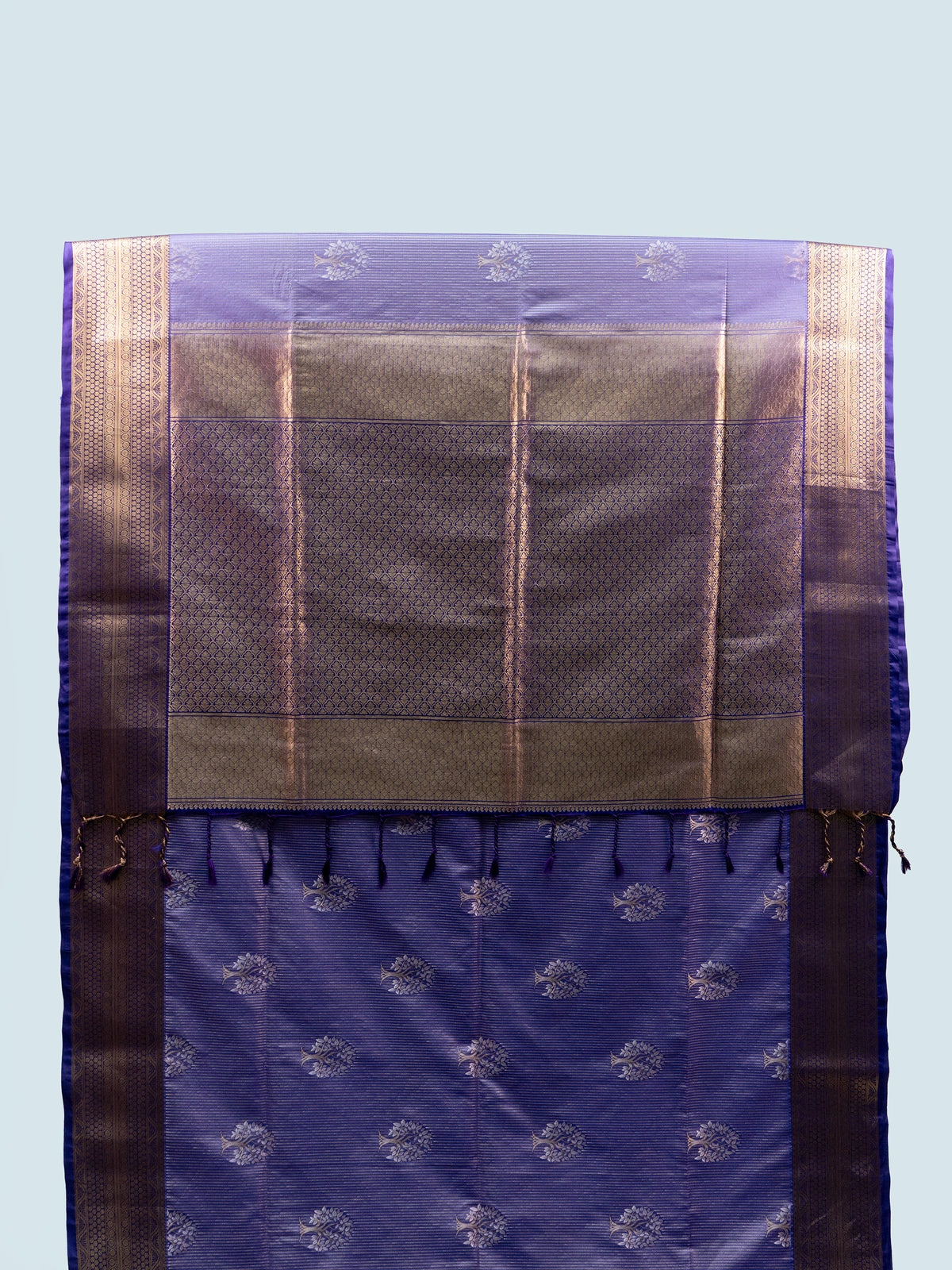 Lavender soft silk saree with gold zari tree motifs, navy blue pallu and black embroidered blouse