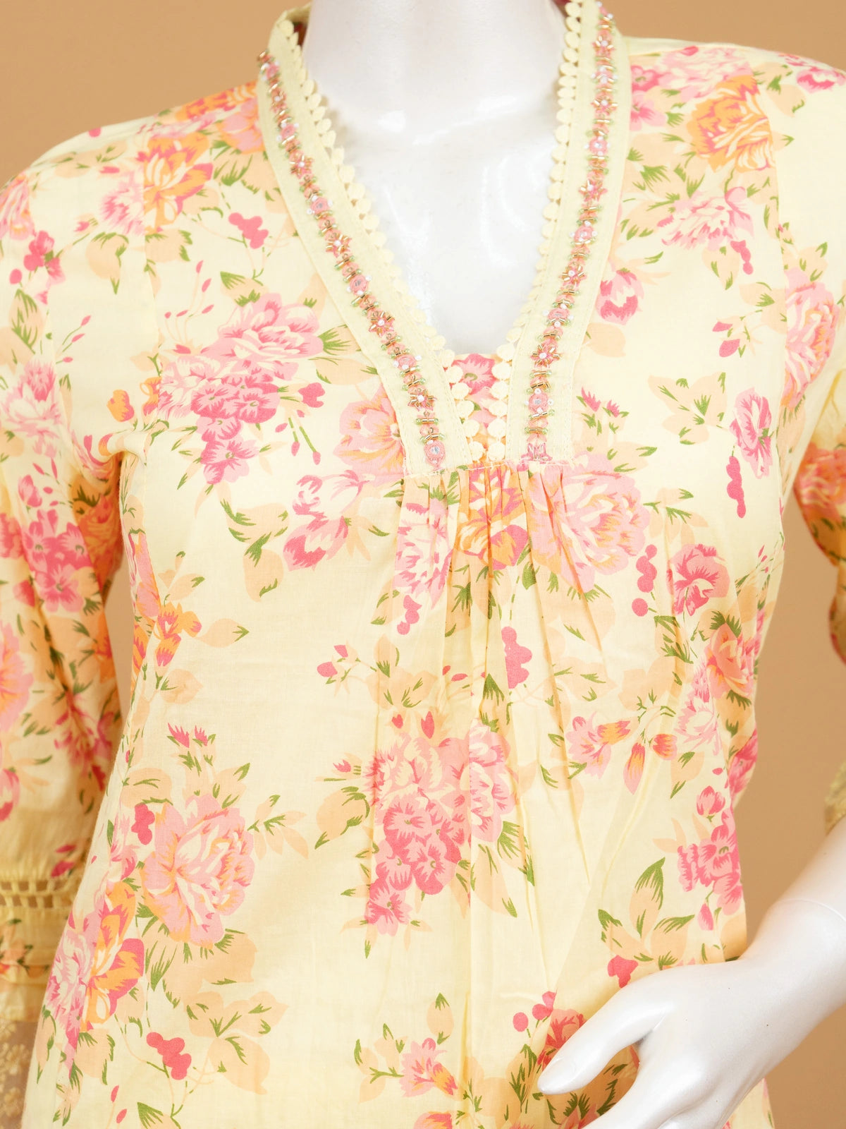 Yellow floral cotton Anarkali kurti set with beaded V-neck, lace cuffs, straight pants, and pink-bordered dupatta