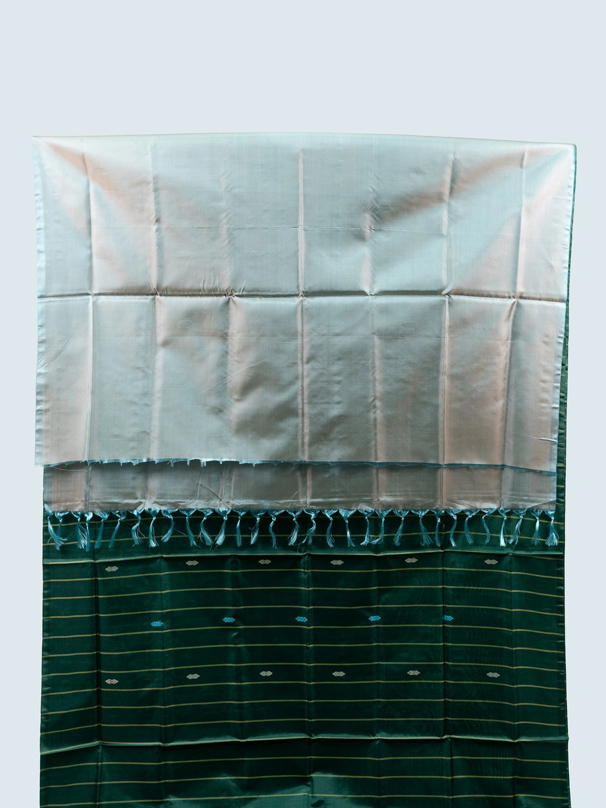 Bottle green banana silk saree with gold zari stripes, woven buti motifs and a contrast silver-grey tasselled pallu