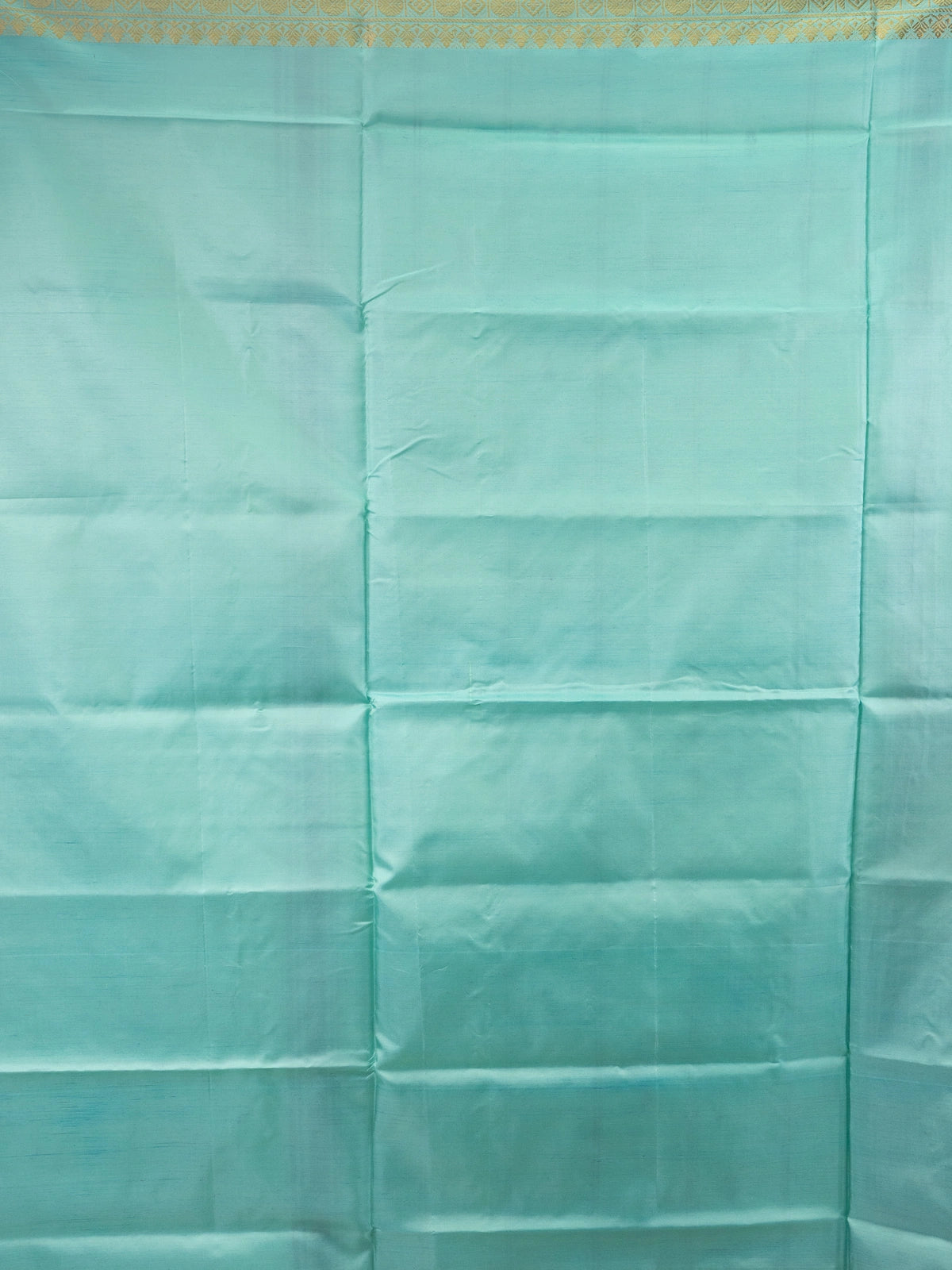 Deep purple Banana Silk saree with contrast turquoise pallu, gold zari border and buti motifs