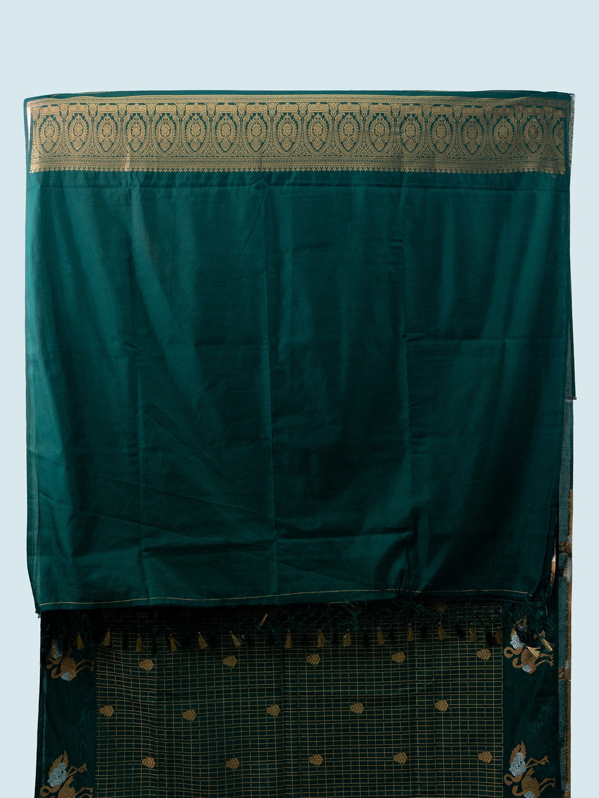 Bottle green semi raw silk saree with gold zari checks, yali motifs and contrast black embroidered blouse