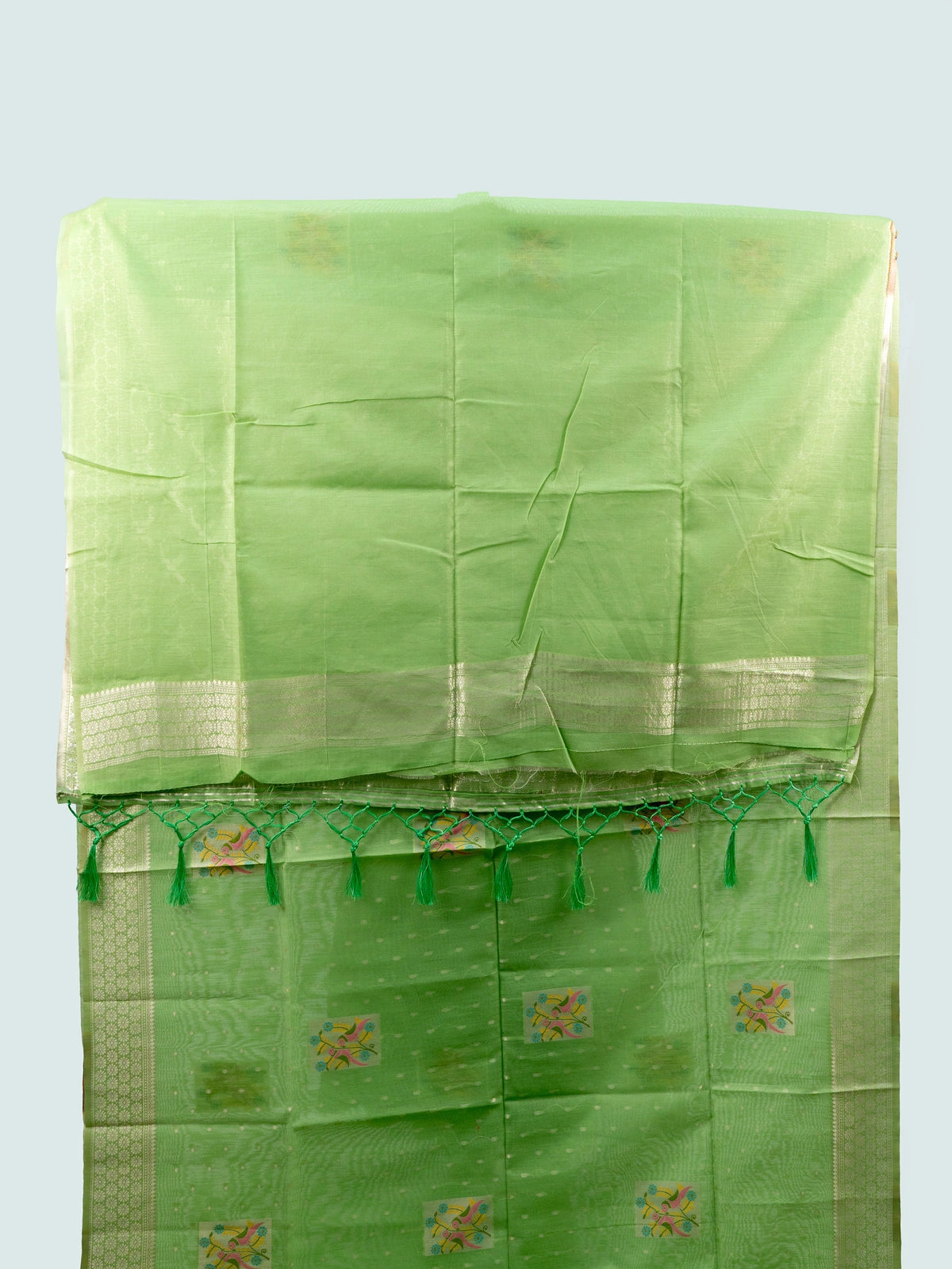 Pista green linen cotton saree with silver zari border and colourful floral buttas