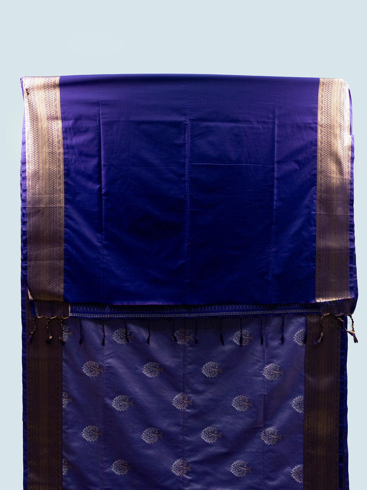 Lavender soft silk saree with gold zari tree motifs, navy blue pallu and black embroidered blouse
