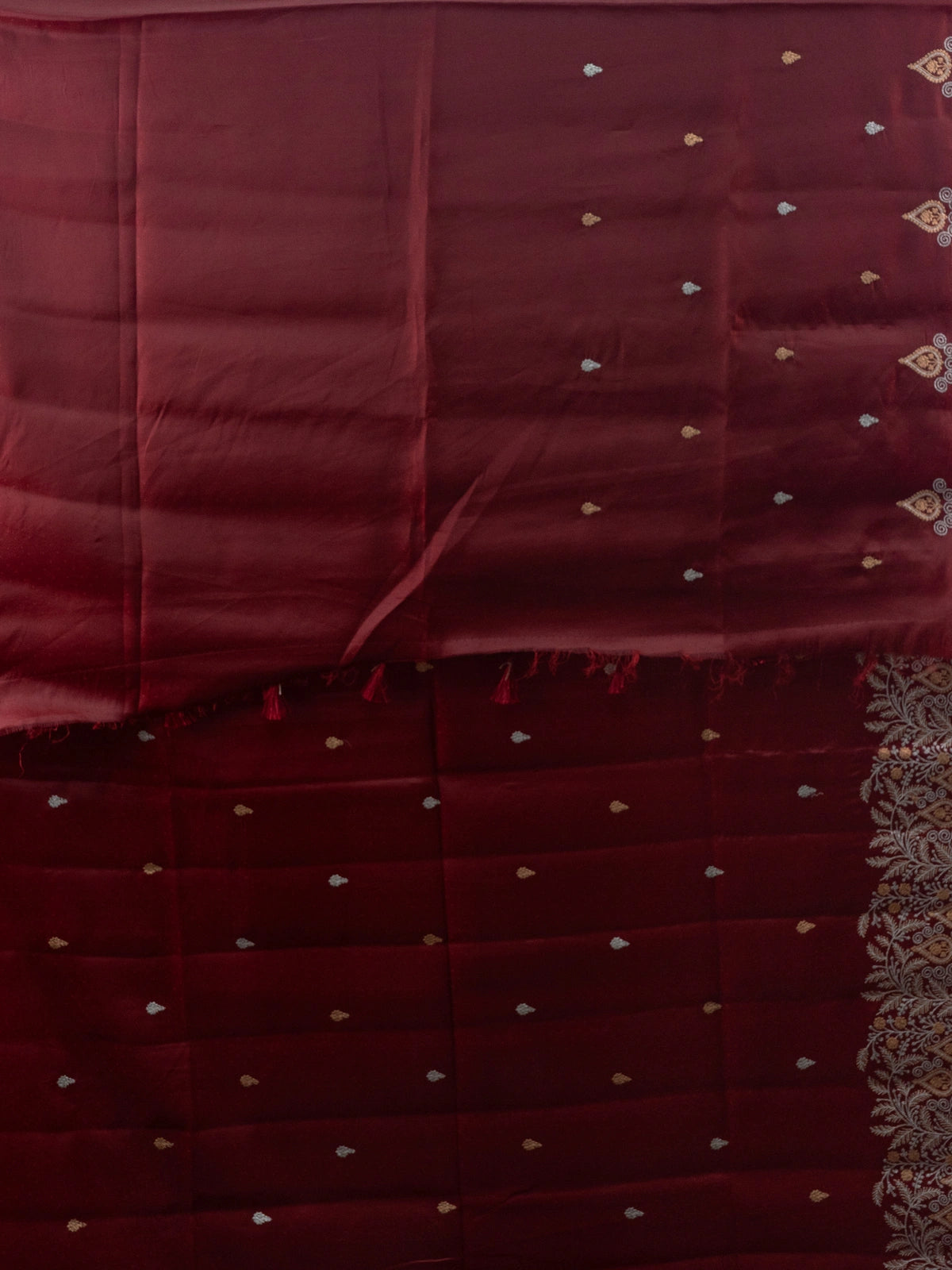 Maroon semi raw silk saree with embroidered pallu, buta motifs and contrast black embroidered blouse