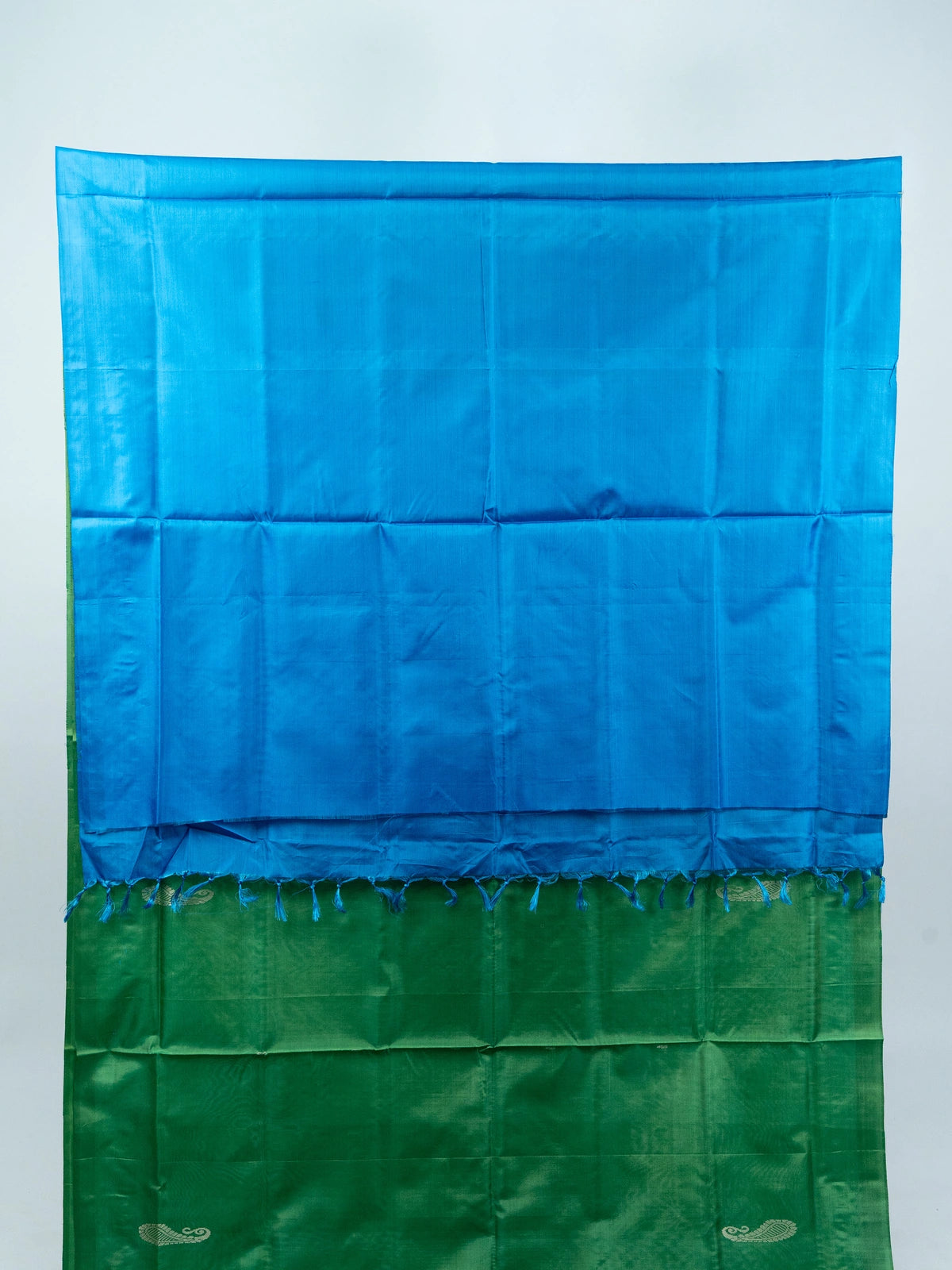 Green banana silk saree with contrast blue pallu, silver paisley motifs and striped border