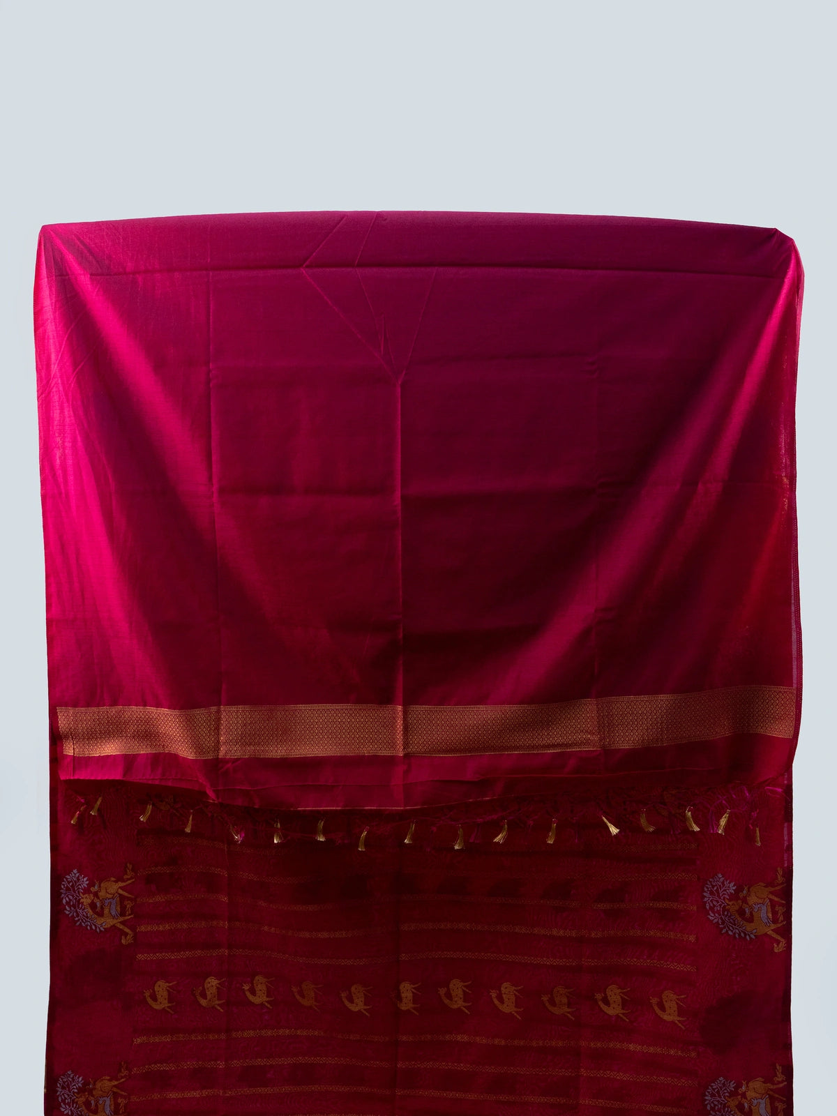 Rani pink semi raw silk saree with gold zari folk motifs, brocade pallu and contrast black blouse