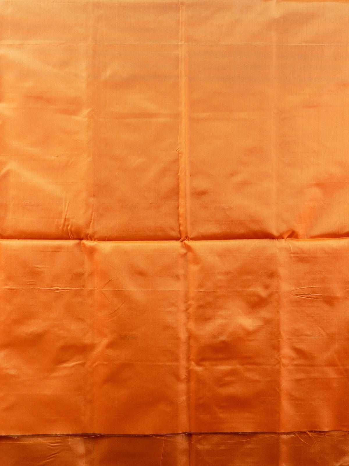 Grey and orange banana silk saree with dual-tone body, zari buttas and a striped contrast orange pallu