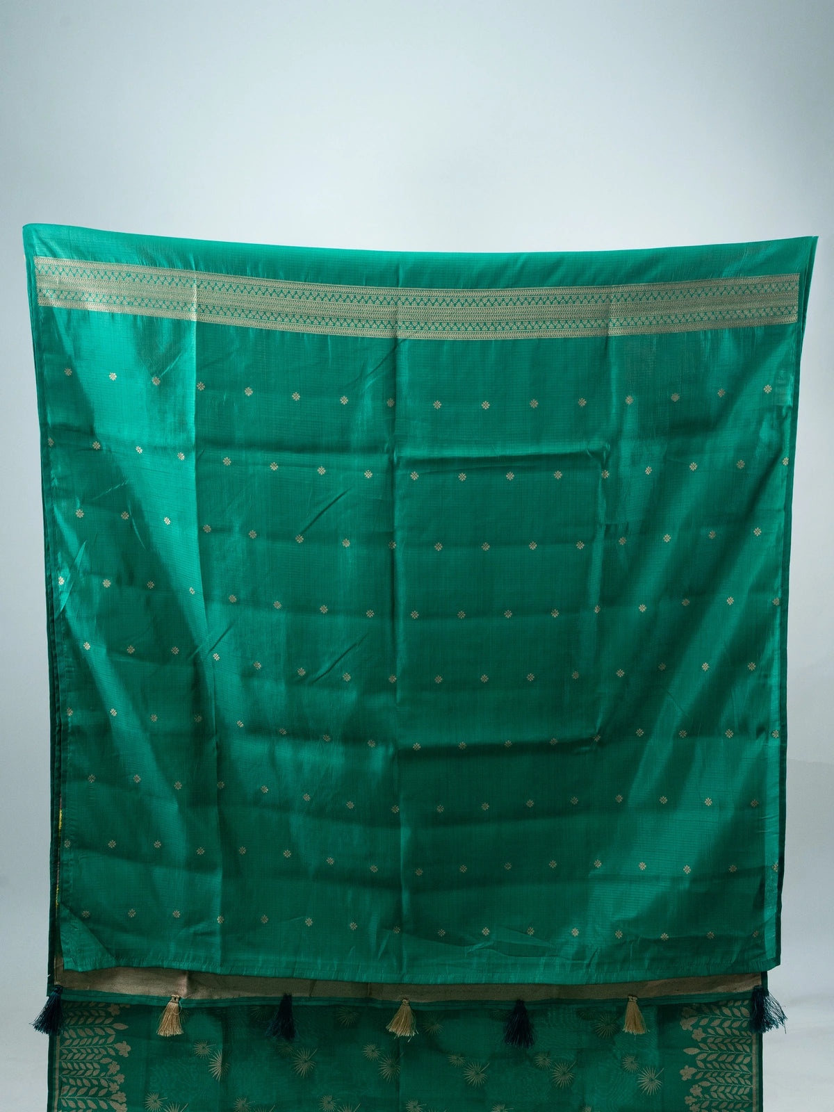 Sea green semi raw silk saree with gold zari floral motifs, woven leaf border and a multicolour floral pallu with contrast black blouse