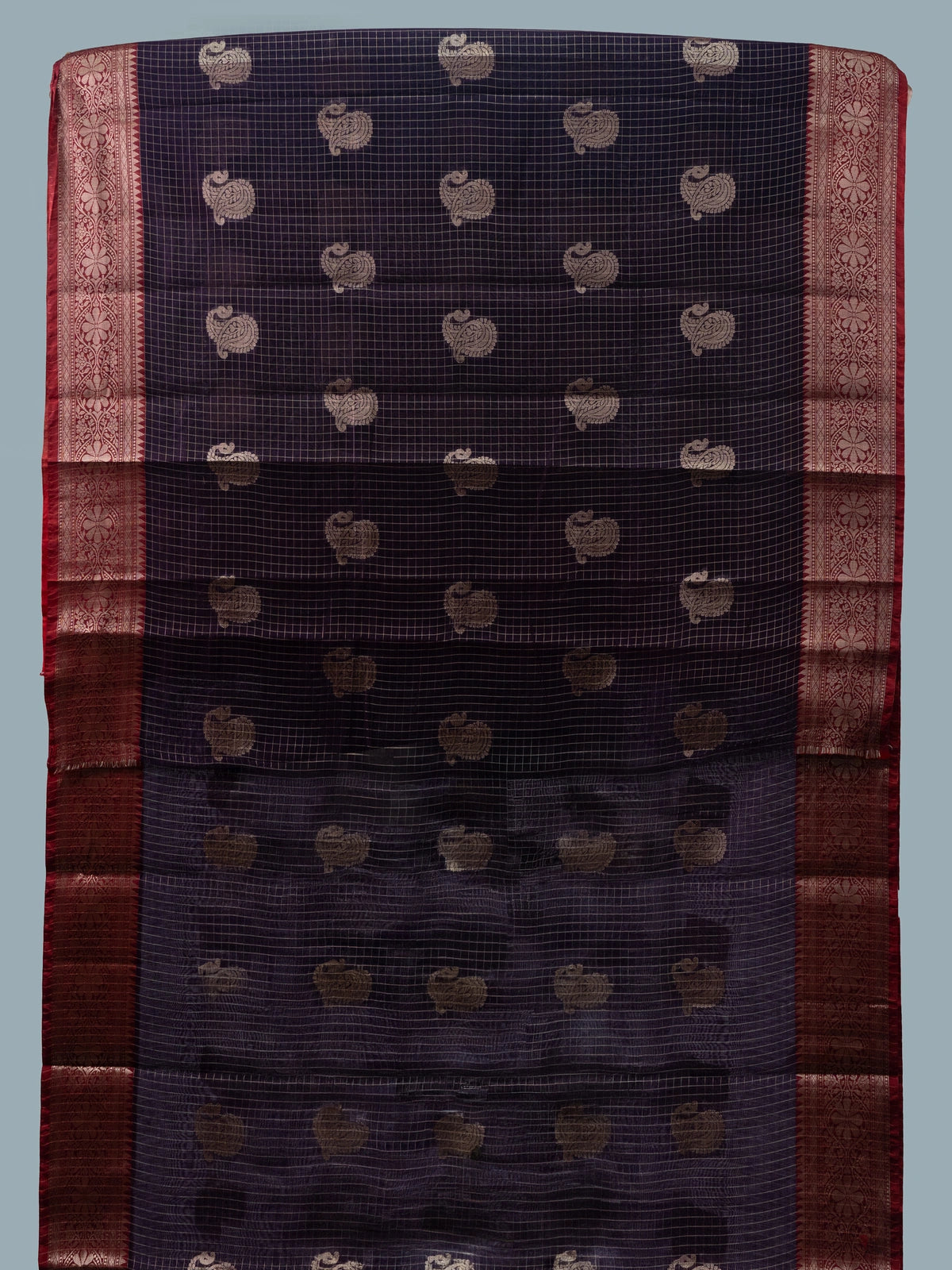 Deep purple semi raw silk saree with zari checks, gold paisley motifs and a contrast red zari border