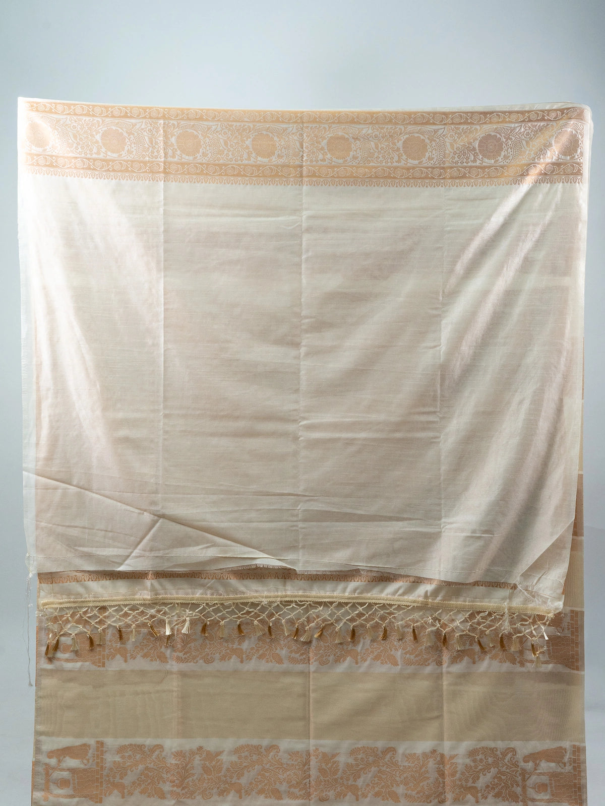 Cream semi raw silk saree with copper woven paisley and floral motifs and a contrasting embroidered black blouse