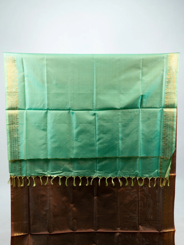 Brown banana silk saree with gold zari border and contrast green striped pallu