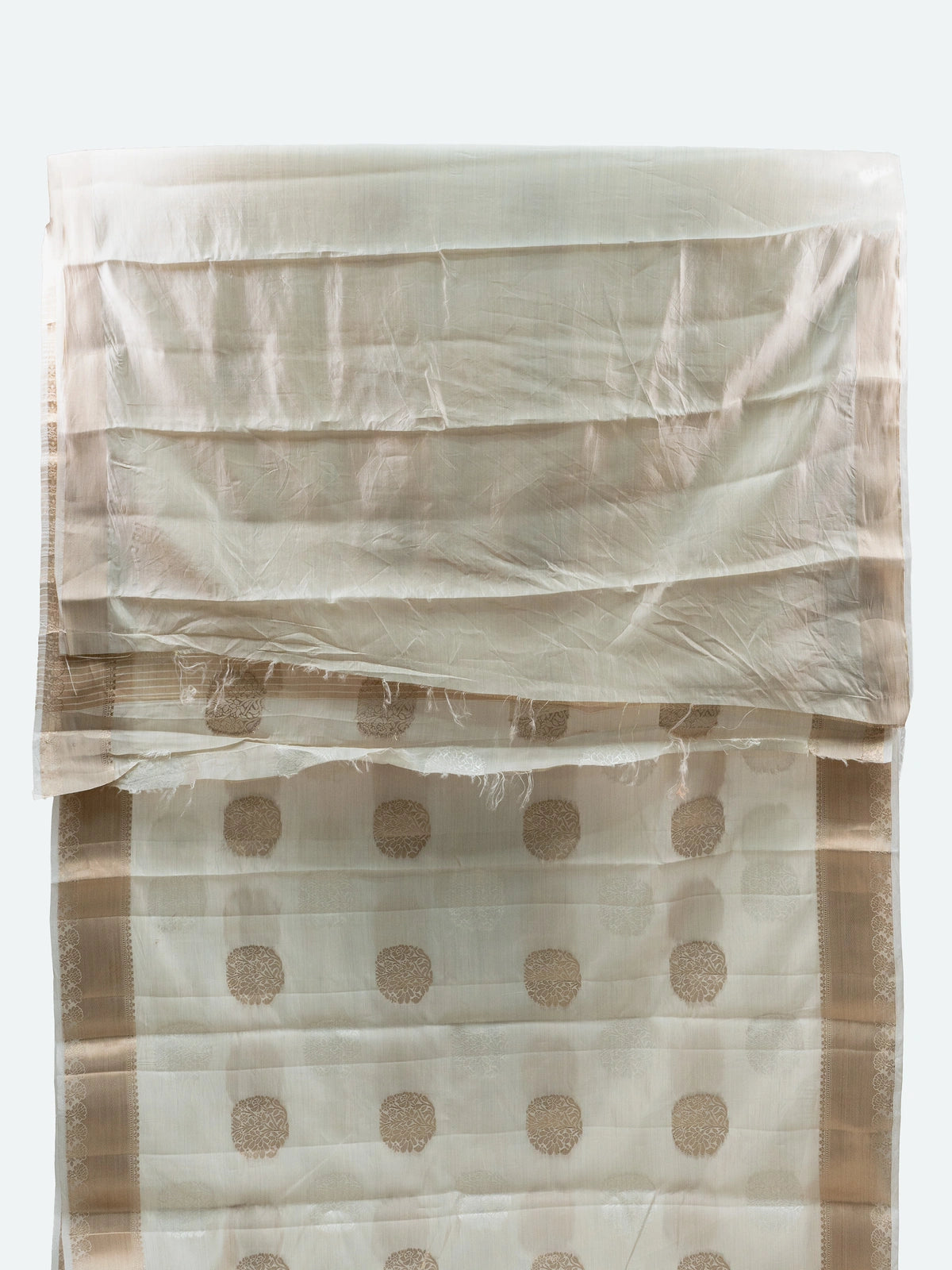 Cream semi raw silk saree with gold zari buttas, gold zari border and contrast black embroidered blouse