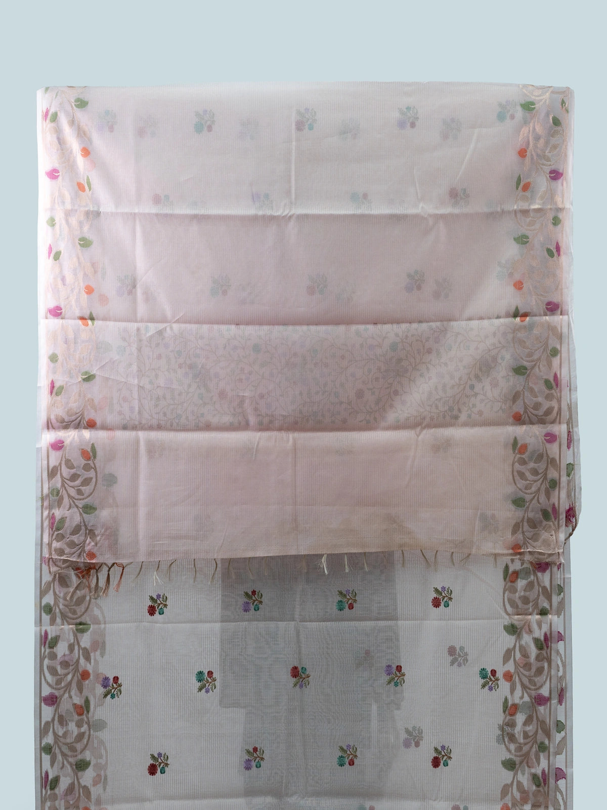 Blush pink linen cotton saree with multicolour floral buttas, gold zari floral border and contrast black embroidered blouse