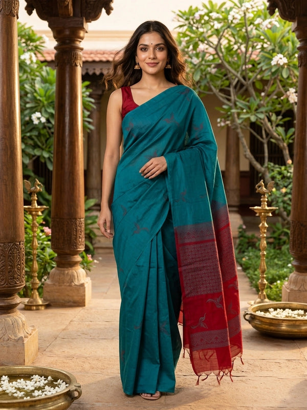 Teal blue pure silk cotton saree with woven bird motifs and contrast red pallu and border