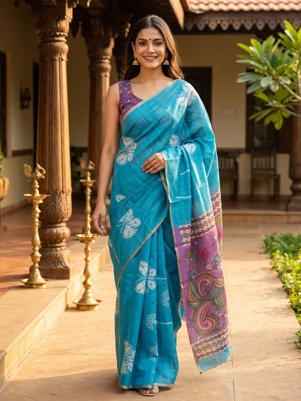 Turquoise blue linen cotton saree with white butterfly prints and a contrast purple Kalamkari pallu