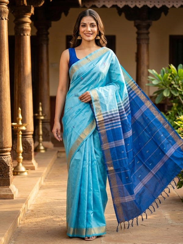 Sky blue banana silk saree with royal blue contrast pallu and gold zari border