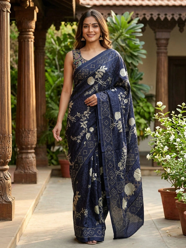Navy blue designer saree with gold floral print, lotus pallu motifs and patola geometric border