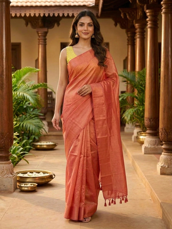 Coral orange and gold tissue designer saree with gold zari border and contrast yellow floral printed blouse