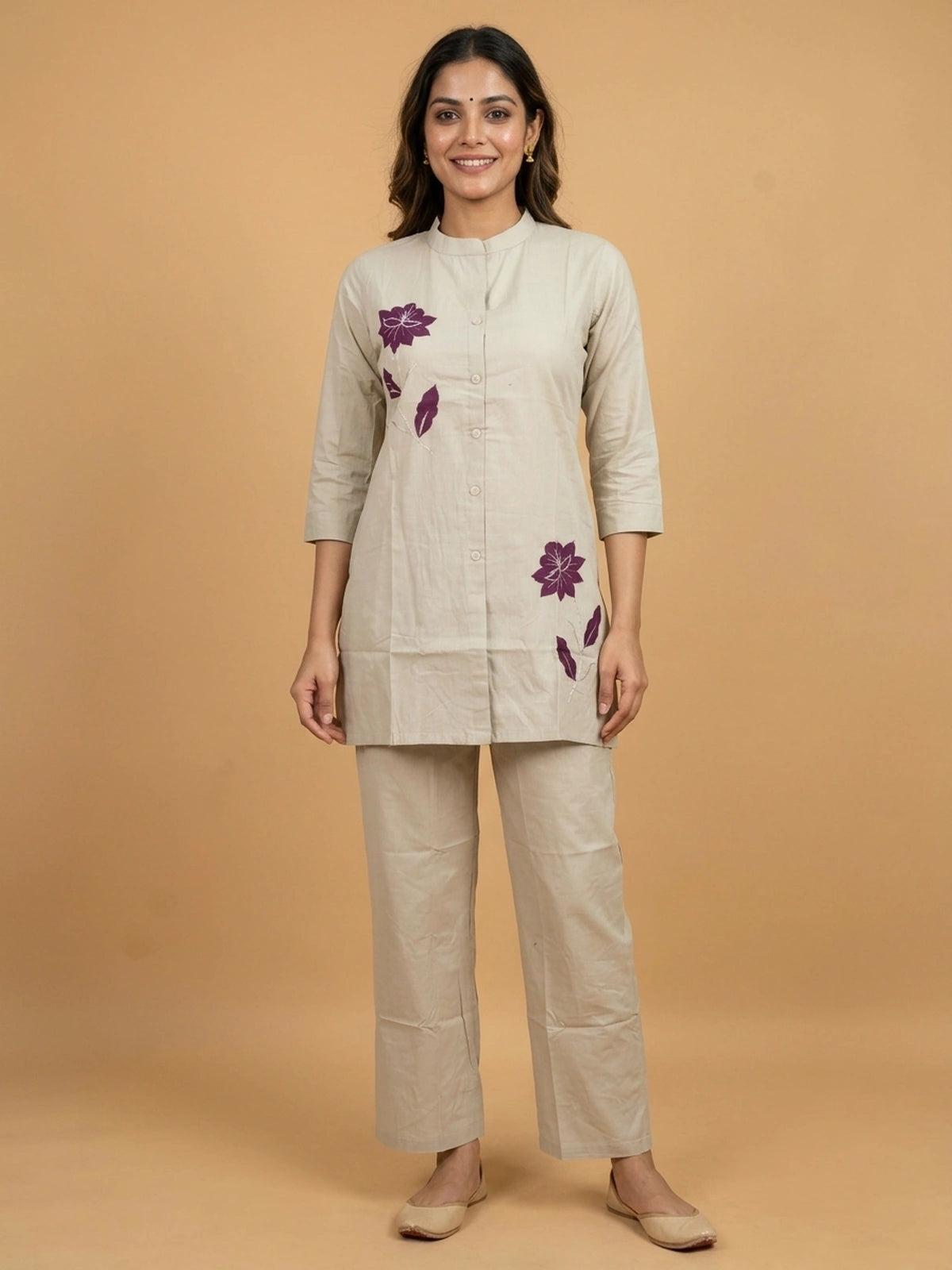 Beige cotton co-ord kurti set with purple floral appliqué motifs and matching straight pants