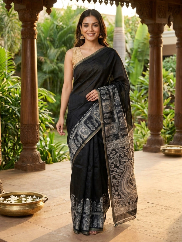 Black linen cotton saree with white Kalamkari-style peacock and floral printed pallu and a slim zari border