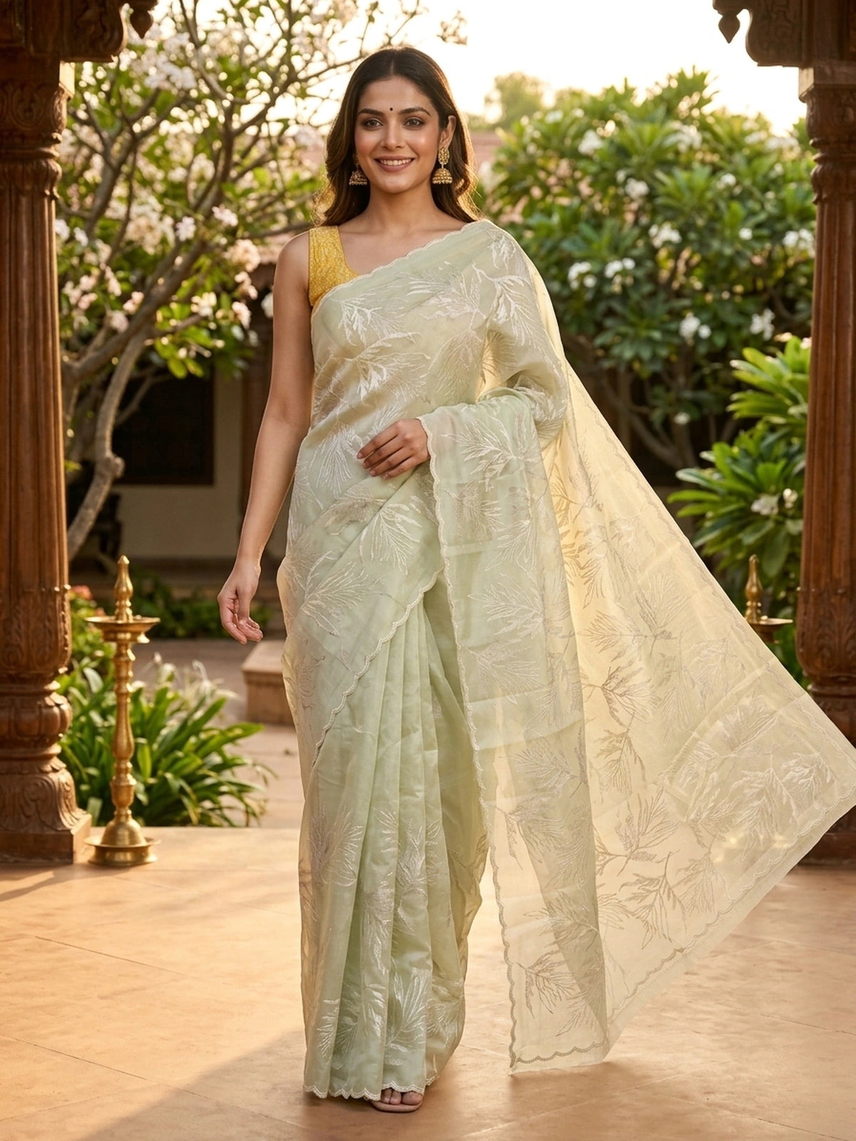 Sage green organza designer saree with white leaf embroidery and contrast yellow blouse