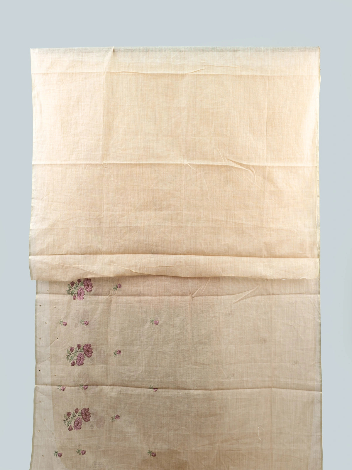 Cream linen cotton saree with mauve floral embroidery, fine zari border and tasseled pallu