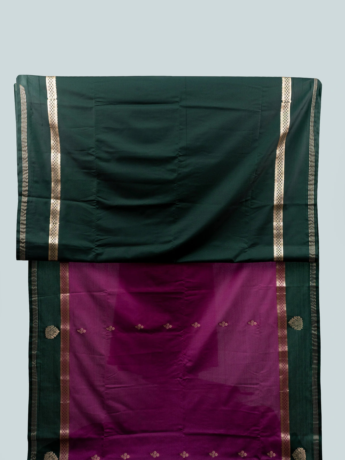 Magenta semi silk saree with dark green gold zari contrast border and floral buttas