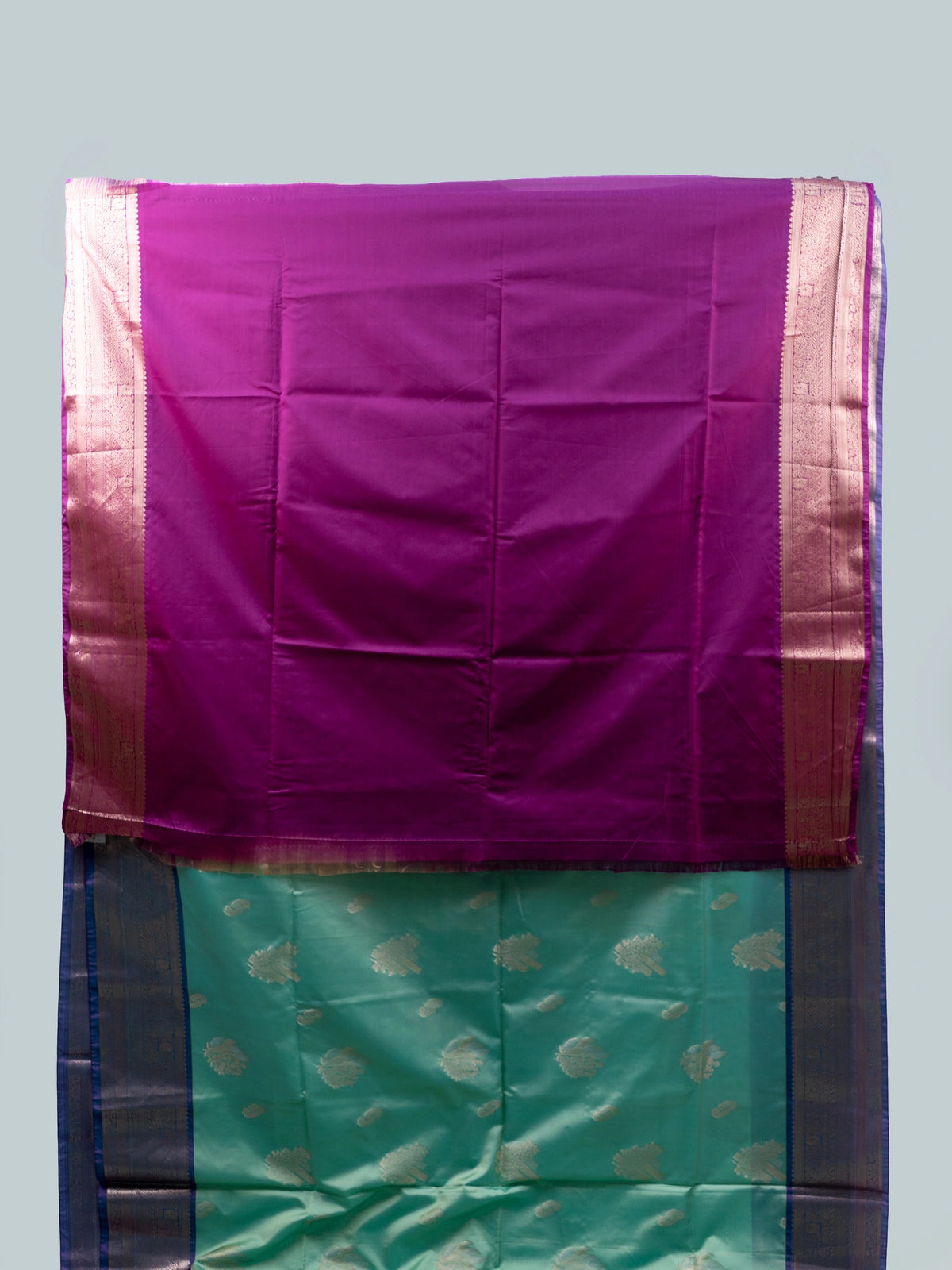 Turquoise and purple semi silk saree with silver zari border and paisley pallu