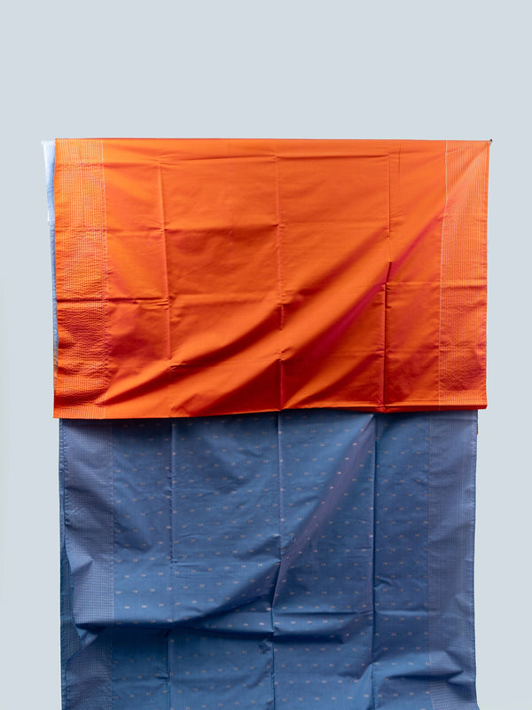 Dusty blue-grey Vaira Oosi Design semi silk saree with silver zari buttis and contrast orange zari pallu and border