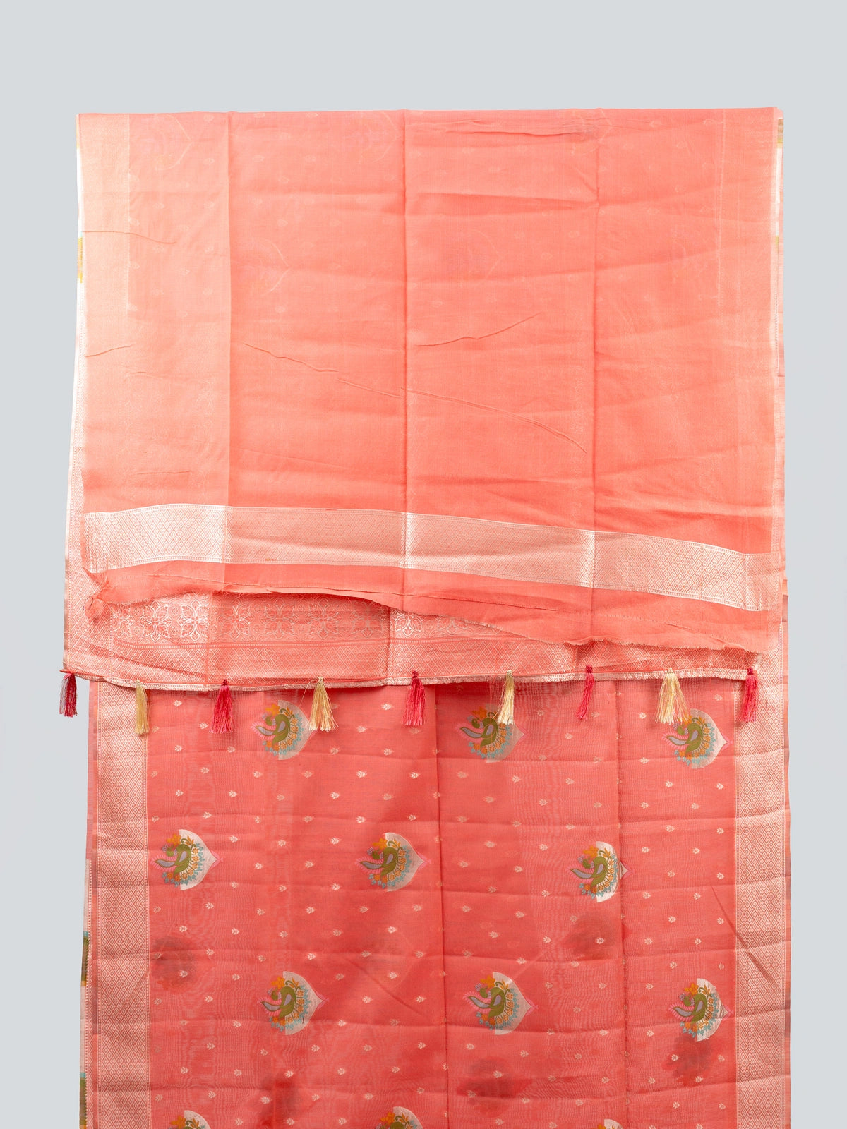 Peach linen cotton saree with silver zari border, peacock motifs and floral zari pallu