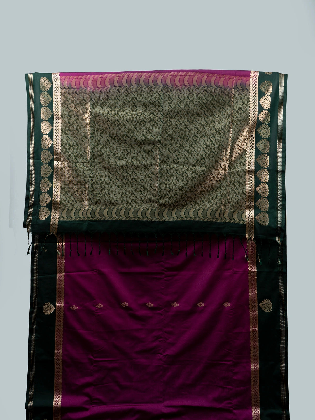 Magenta semi silk saree with dark green gold zari contrast border and floral buttas