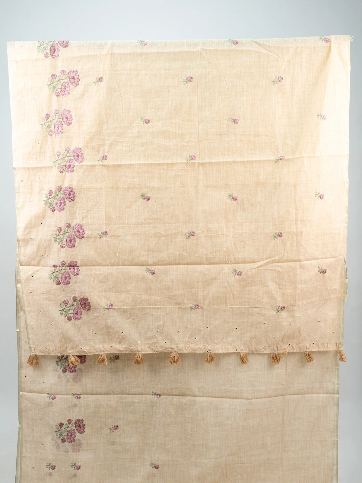 Cream linen cotton saree with mauve floral embroidery, fine zari border and tasseled pallu