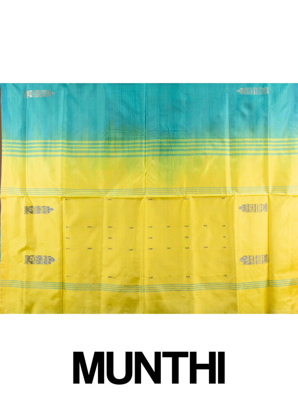 Teal banana silk saree with yellow contrast pallu, silver zari buttas, and matching yellow blouse