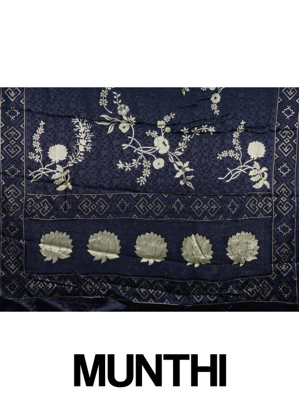 Navy blue designer saree with gold floral print, lotus pallu motifs and patola geometric border