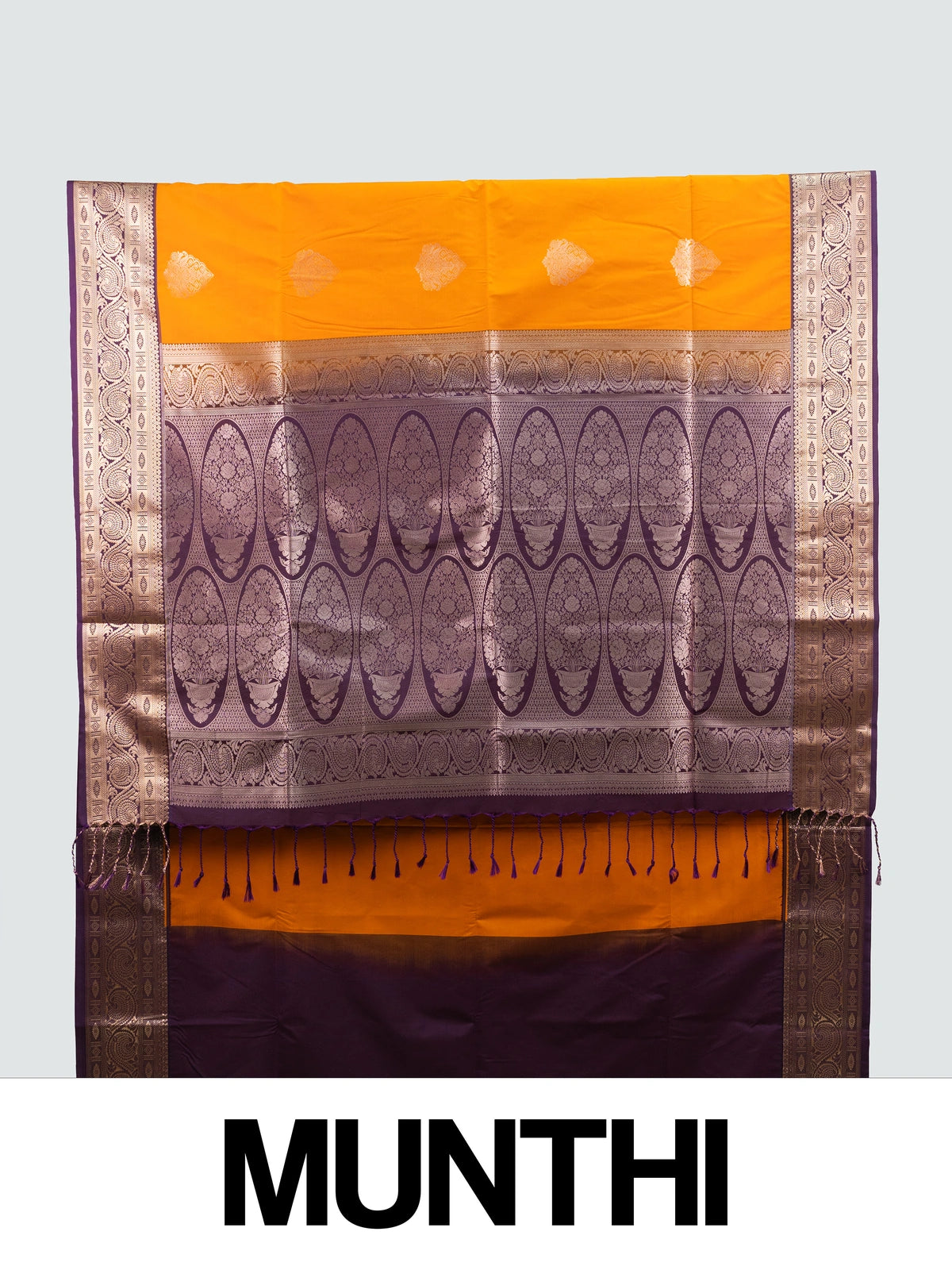 Mustard semi silk saree with contrast purple gold zari border, zari buttas, and ornate woven pallu
