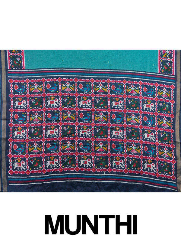 Teal linen cotton saree with navy and pink patola-style border, peacock and elephant motifs, and contrast blouse