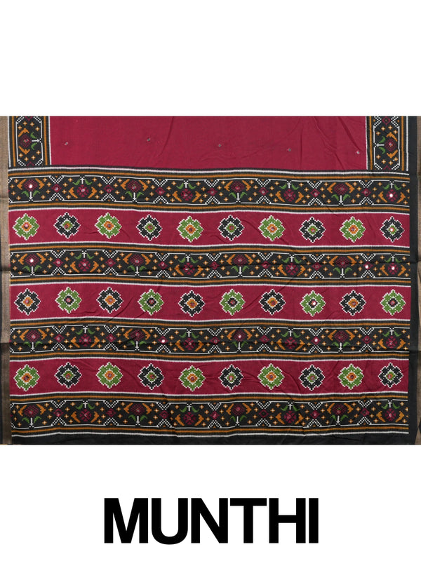 Maroon Dola silk saree with black patola-style border, multicolour pallu and mirror work