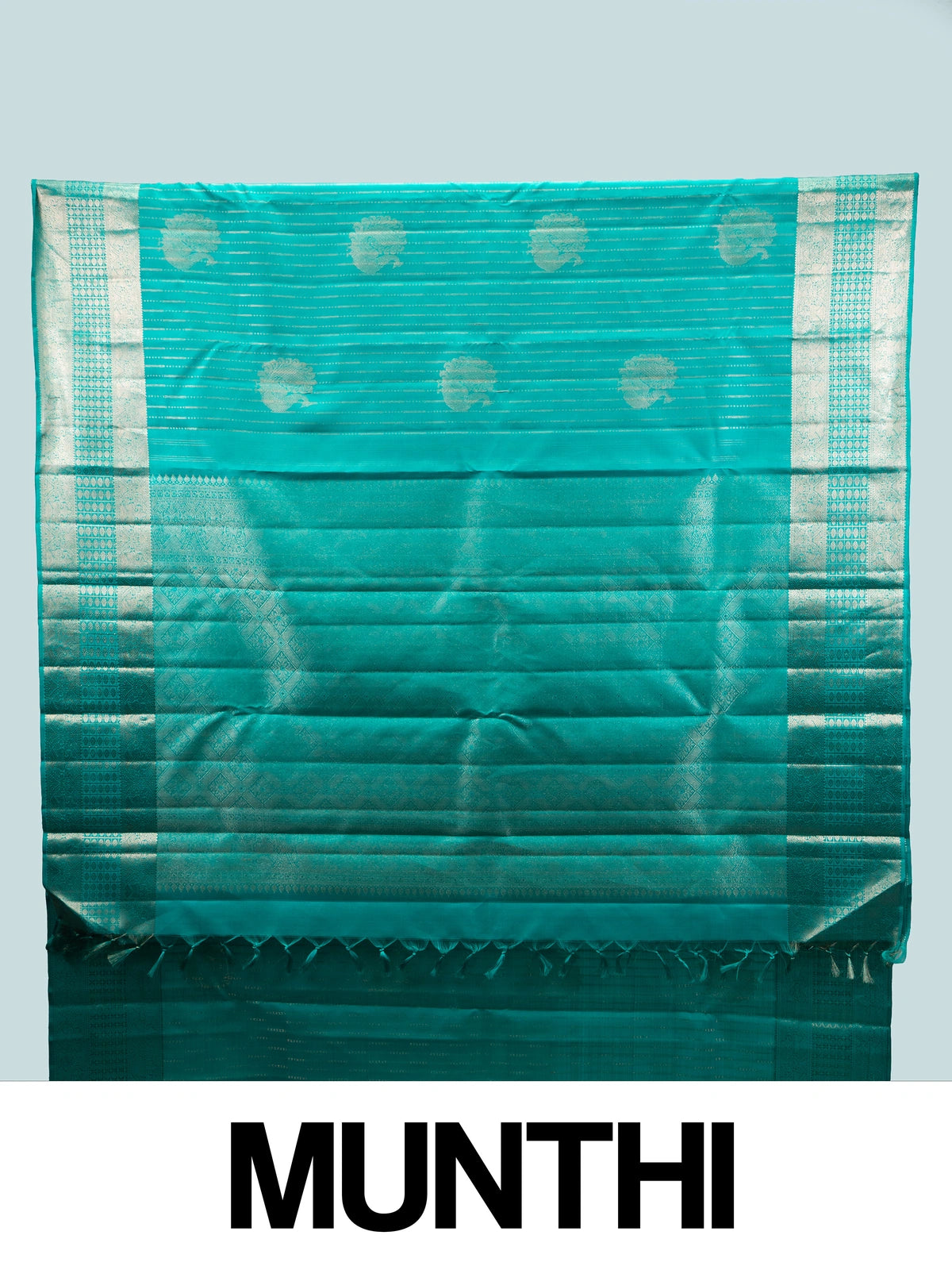 Teal green Pure Kanchipuram silk saree with silver zari diagonal stripes, peacock buttas and a woven zari border