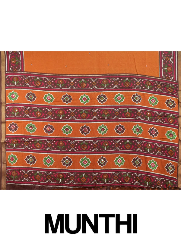 Rust orange linen cotton saree with patola-print brown border, mirror-work buttis and contrast blouse