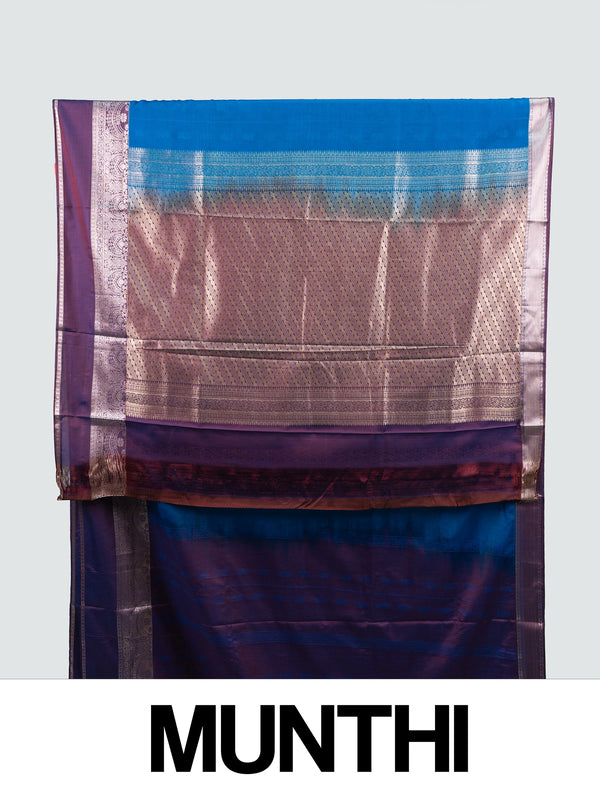 Peacock blue semi silk saree with contrast purple border and silver zari pallu