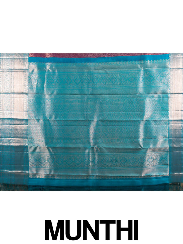 Purple pure Kanchipuram silk saree with silver zari floral weaving and contrast teal blue border and pallu