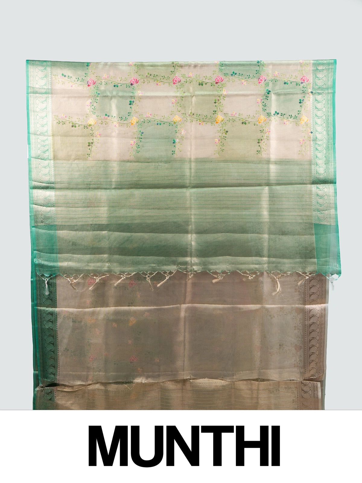 Cream and green semi raw silk saree with multicoloured floral vines and a green zari border