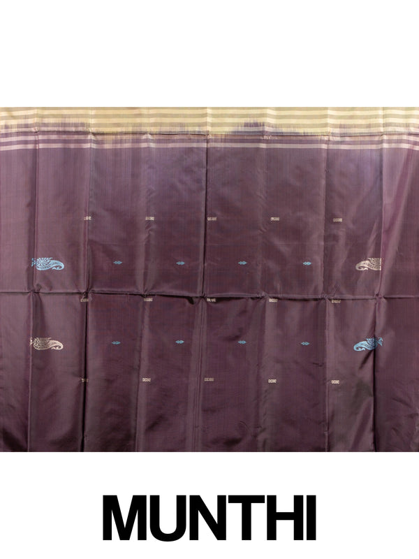 Golden yellow banana silk saree with plum contrast pallu, zari stripes and paisley buttas