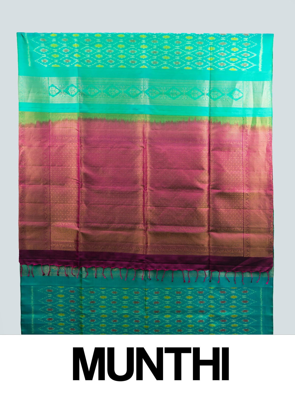 Teal green soft silk saree with ikat motifs, gold zari border and contrast magenta zari pallu